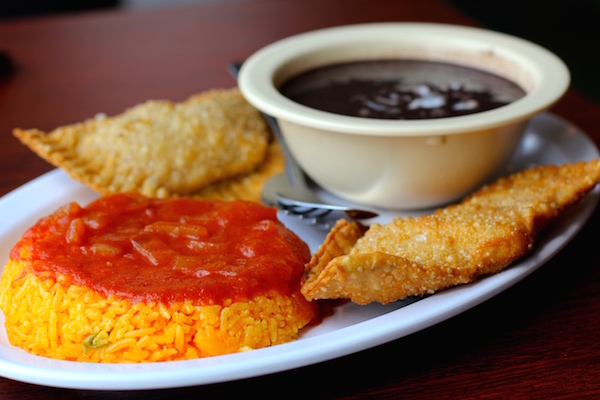 The empanada plate served with beans and rice.