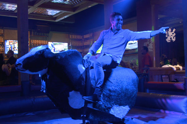 customer riding a mechanical bull at PBR Atlanta 
