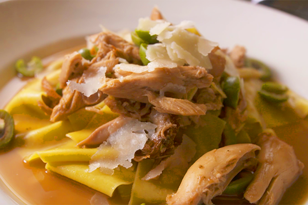 Pappardelle con coniglio is large, flat pasta noodles served with braised rabbit, castelvetrano olive, and grana padano (shaved cheese). They utilize whole rabbits and then use it as a broth to braise the rabbits in.