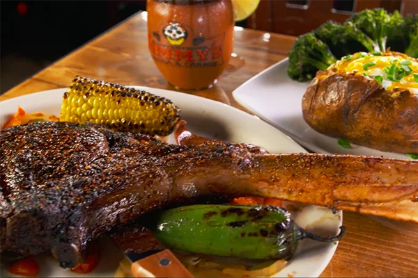 Jimmy’s describes this dish “so good it should be a crime.” This 32 ounce Tomahawk steak is perfectly seasoned and grilled, and served with grilled corn, jalapenos, sausage, rice, and beans.