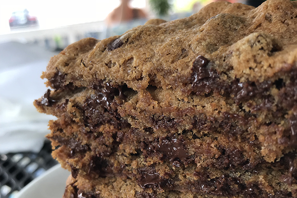 a stack of chocolate chip cookies from Karma Daisy