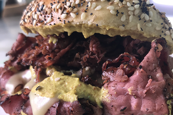 pastrami with spicy mustard on an everything bagel