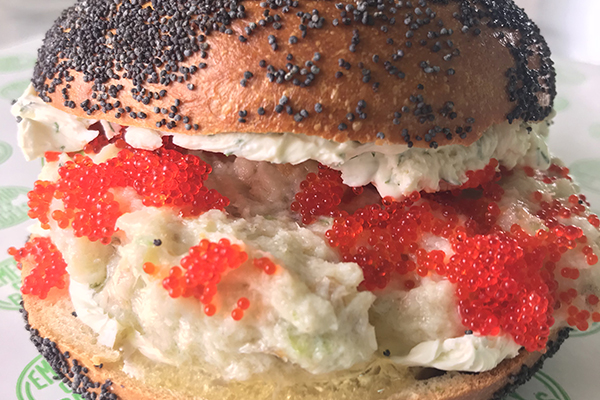 whitefish salad bagel with red caviar on a poppy seed bagel