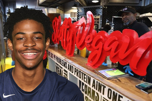 Ja Moront in front of the Slutty Vegan sign