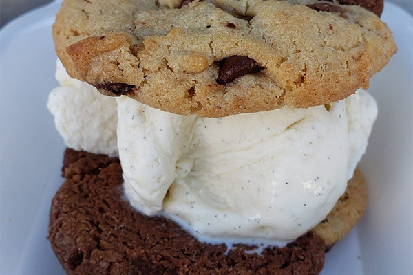 Not As Famous Cookie Sandwich showing classic vanilla ice cream, one of our featured black-owned restaurants in Atlanta | Photo: Courtesy of Not As Famous Cookie