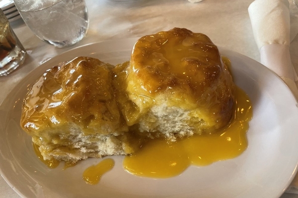 two biscuits covered in honey butter from the real milk & honey in college park, GA