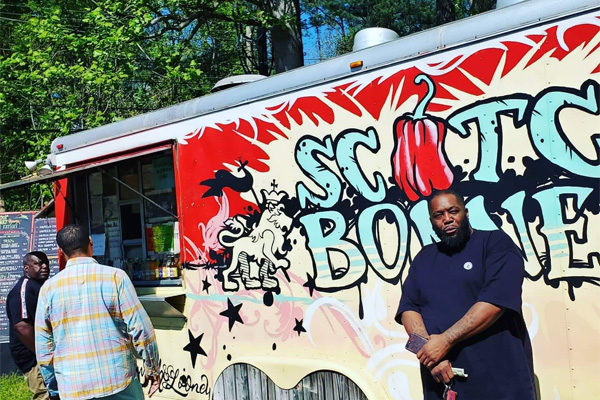 Scotch Bonnet Jamaican Eatery - Killer Mike In Front of the Truck | Photo: Facebook//TheScotchBonnet
