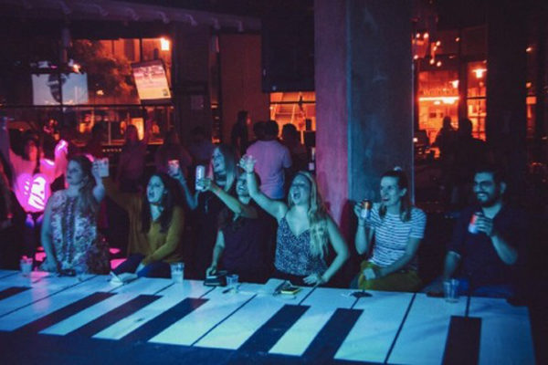 Revelers drinking and enjoying the show at Park Bench at the Battery.