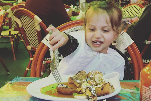 A child enjoying French Toast at R. Thomas.