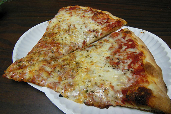 Two slices of thick-crust pizza on two white paper plates