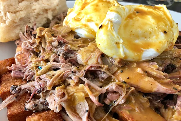 Pulled pork and eggs over potatoes