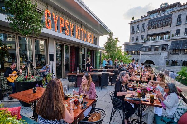 Groups of customers sitting on rooftop patio at Gypsy Kitchen 
