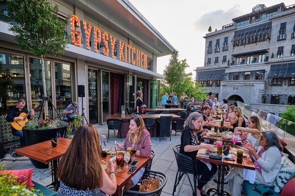 Groups of customers sitting on rooftop patio at Gypsy Kitchen