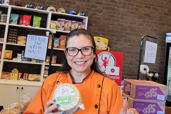 Mimi of Mimi's Arepas holding one of her prepackaged arepas.