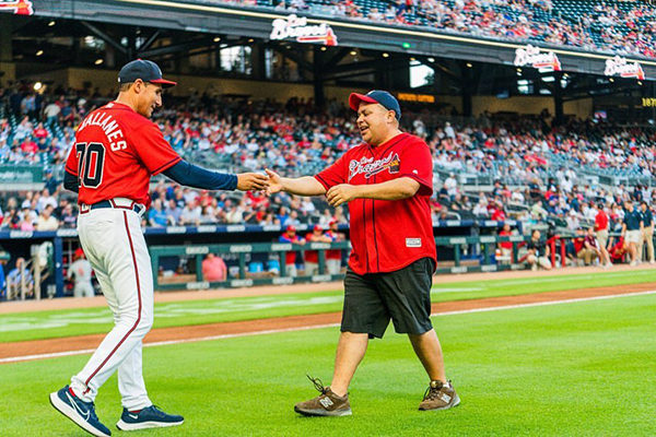 Latin American Association CEO Santiago Marquez throws out the first bitch at the Braves Game on Los Bravos Night.