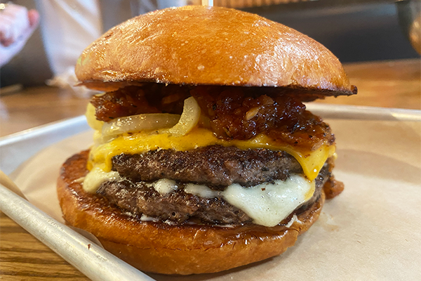 Double cheeseburger with tomato bacon jam and grilled onions