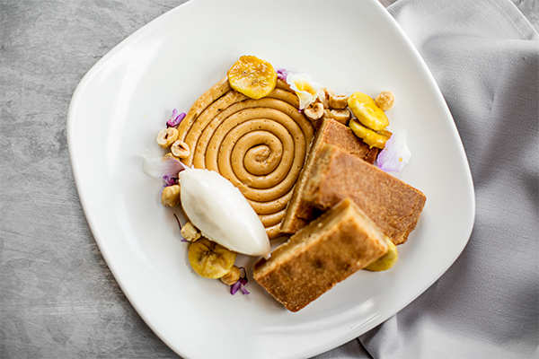 Blondie dessert with bananas, ice cream, hazelnuts, and more