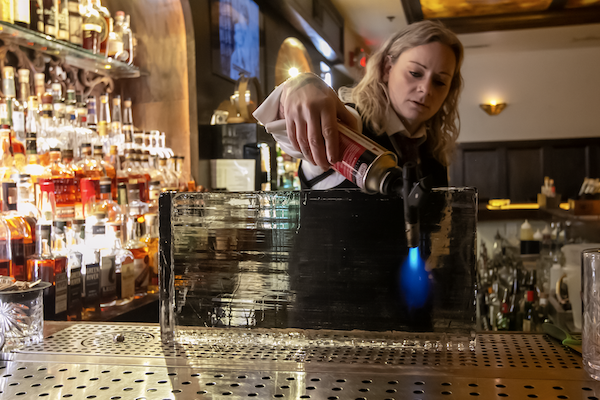 A bartender prepping ice at Red Phone Booth