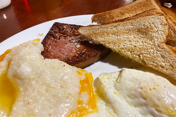 Ham, toast, cheese grits, and fried egg 