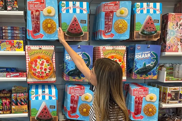 A customer picks out gummy shaped goodies at It'Sugar in Atlantic Station.