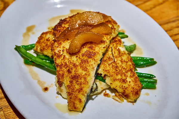 Filets of trout covered with brown butter peaches and atop green beans