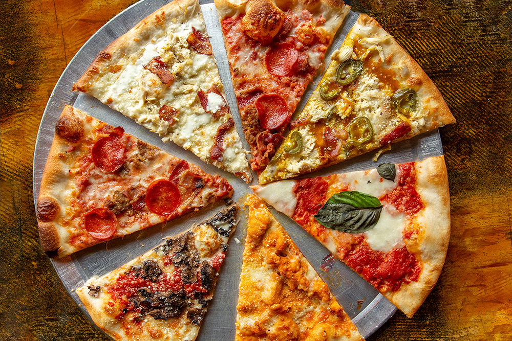A variety of pizza slices from Karvelas Pizza Co.