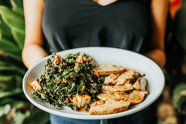 Salad with sliced chicken on a white plate